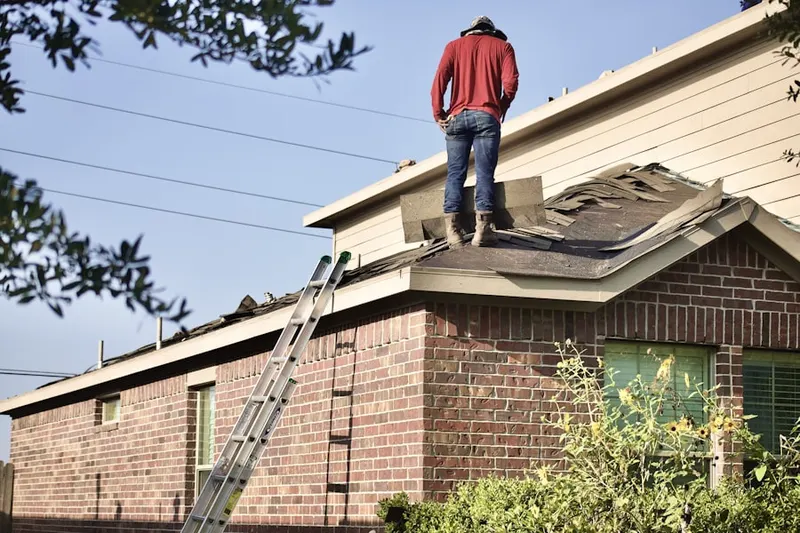 Professional roofer working on a residential roof in Pimmit Hills